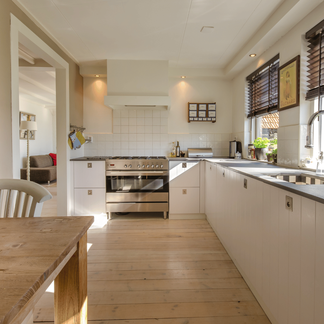A kitchen with stainless steel appliances and white cabinets