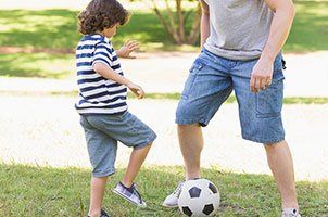 dad and son playing football
