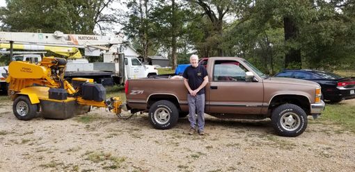 Man in Black Shirt Leaning on Car — Rogersville, AL — Complete Tree Service