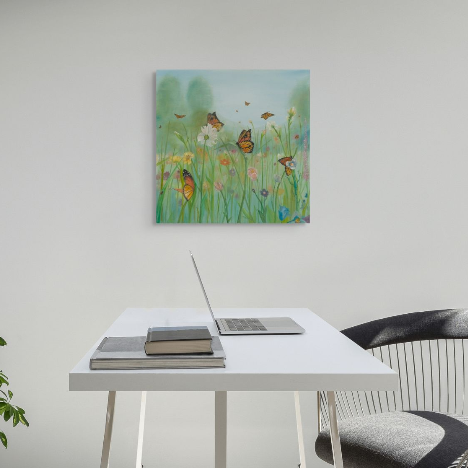 A painting of butterflies in a field hangs above a table with a flower vase, bread, and eggs.