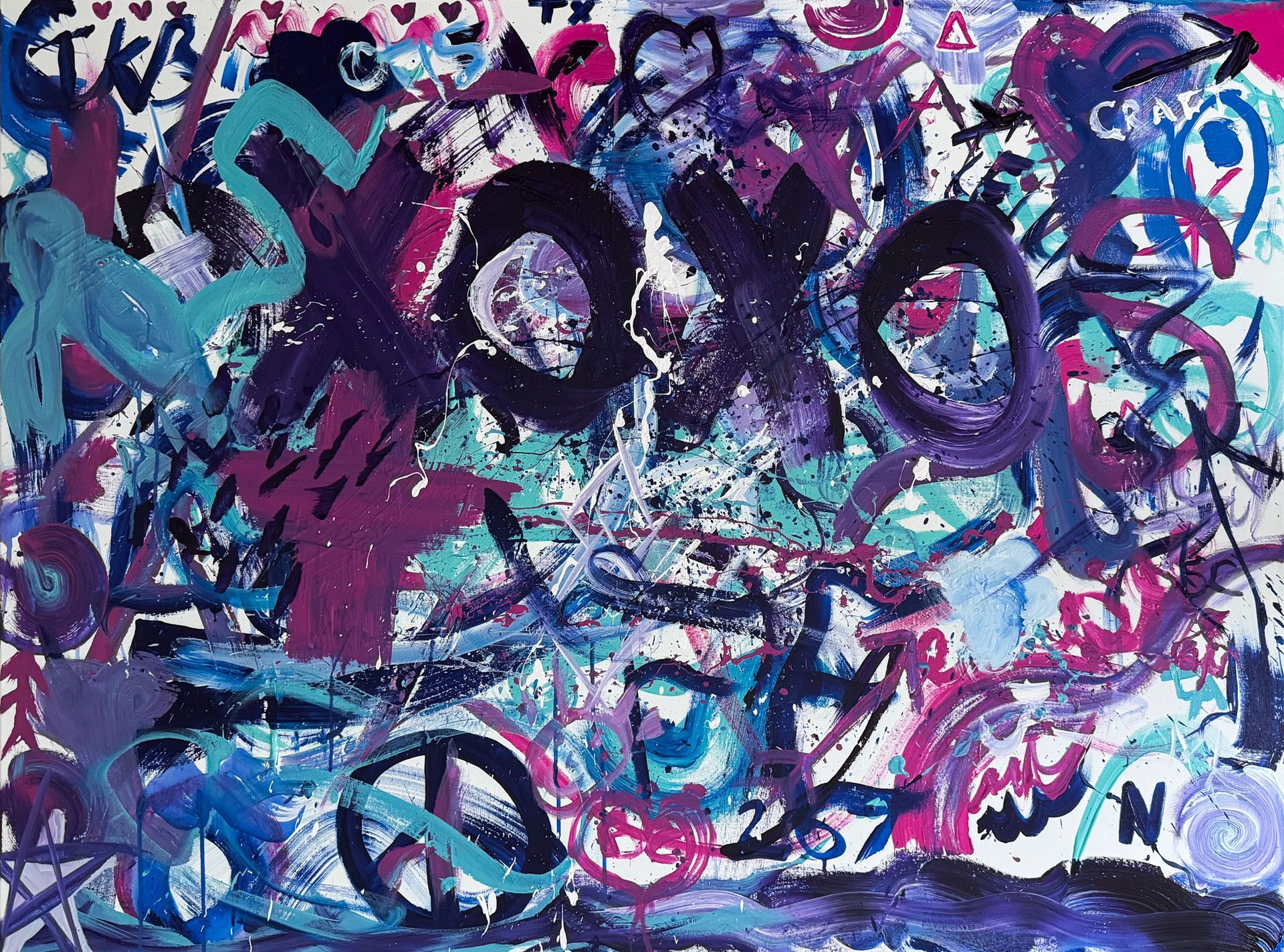 A close up of a colorful painting with graffiti on it.