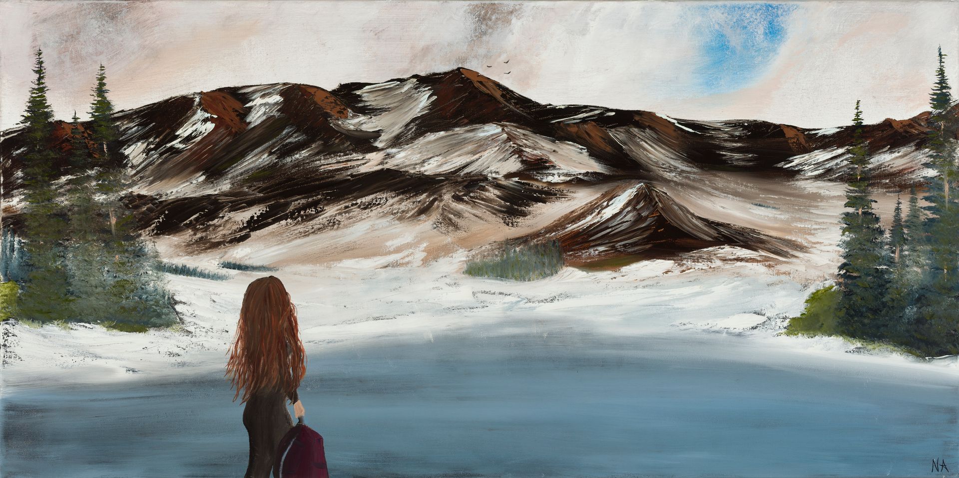 Backpacker looking toward snowy mountains and pine trees by a frozen lake