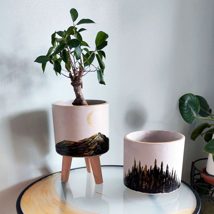 a set of hand painted  half moon planter pots with mountains and trees on a hand painted half moon accent table from art by Nicole Ann