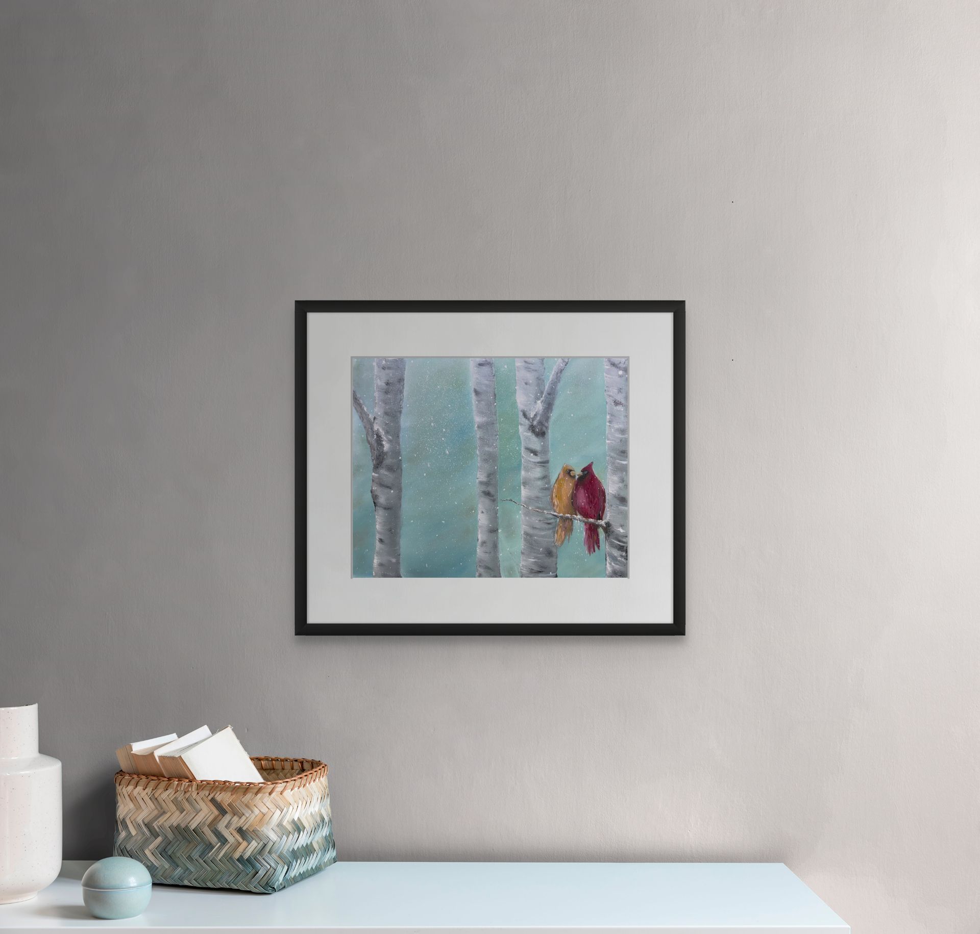Painting of a white horse emerging from ocean waves on a rocky shore, framed on a gray wall.