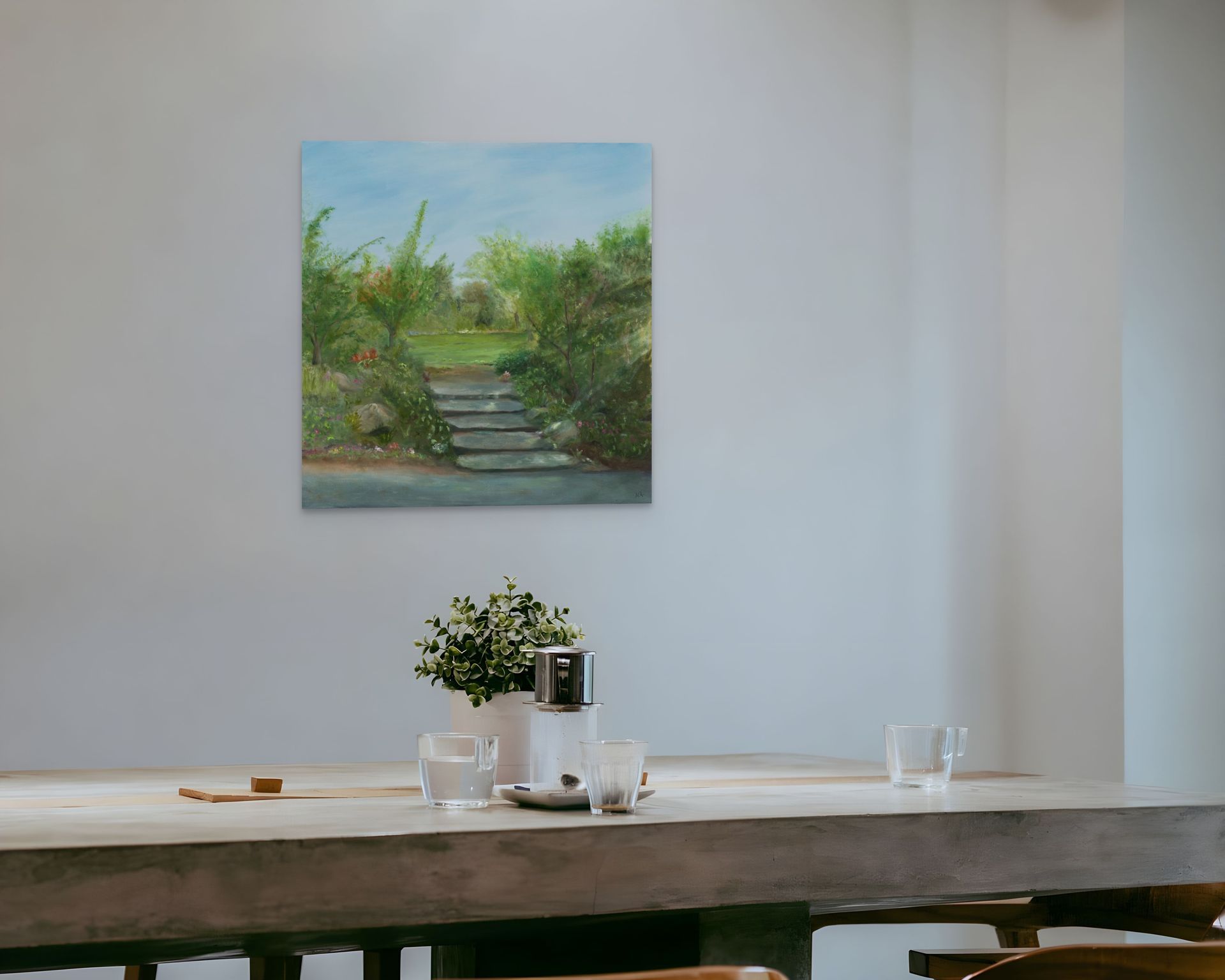 Two paintings of a horse on a beach are on an easel.