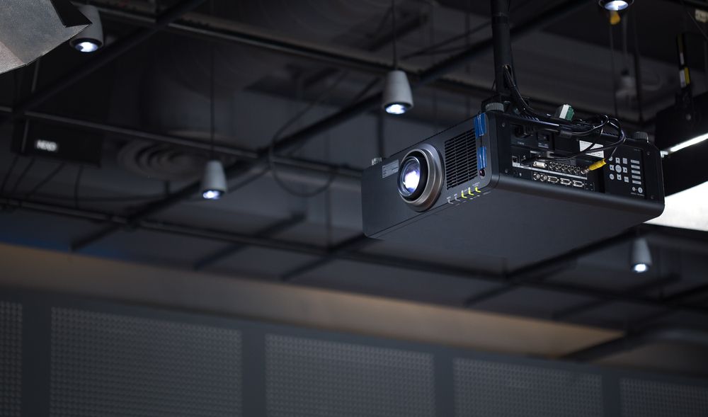 Black Projector Mounted on a Dark Ceiling, With Spotlights — IRIS CCTV in South Grafton, NSW