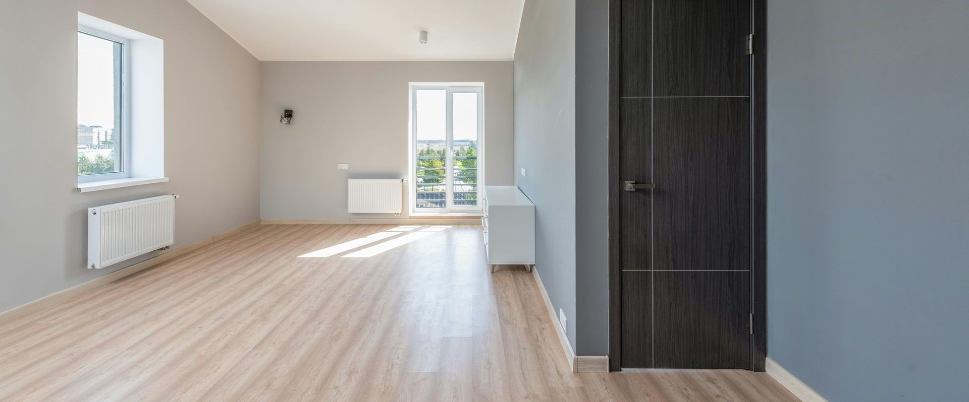 A cleaned post construction site by Mountain Tops Cleaning Service with a open floor, and door.