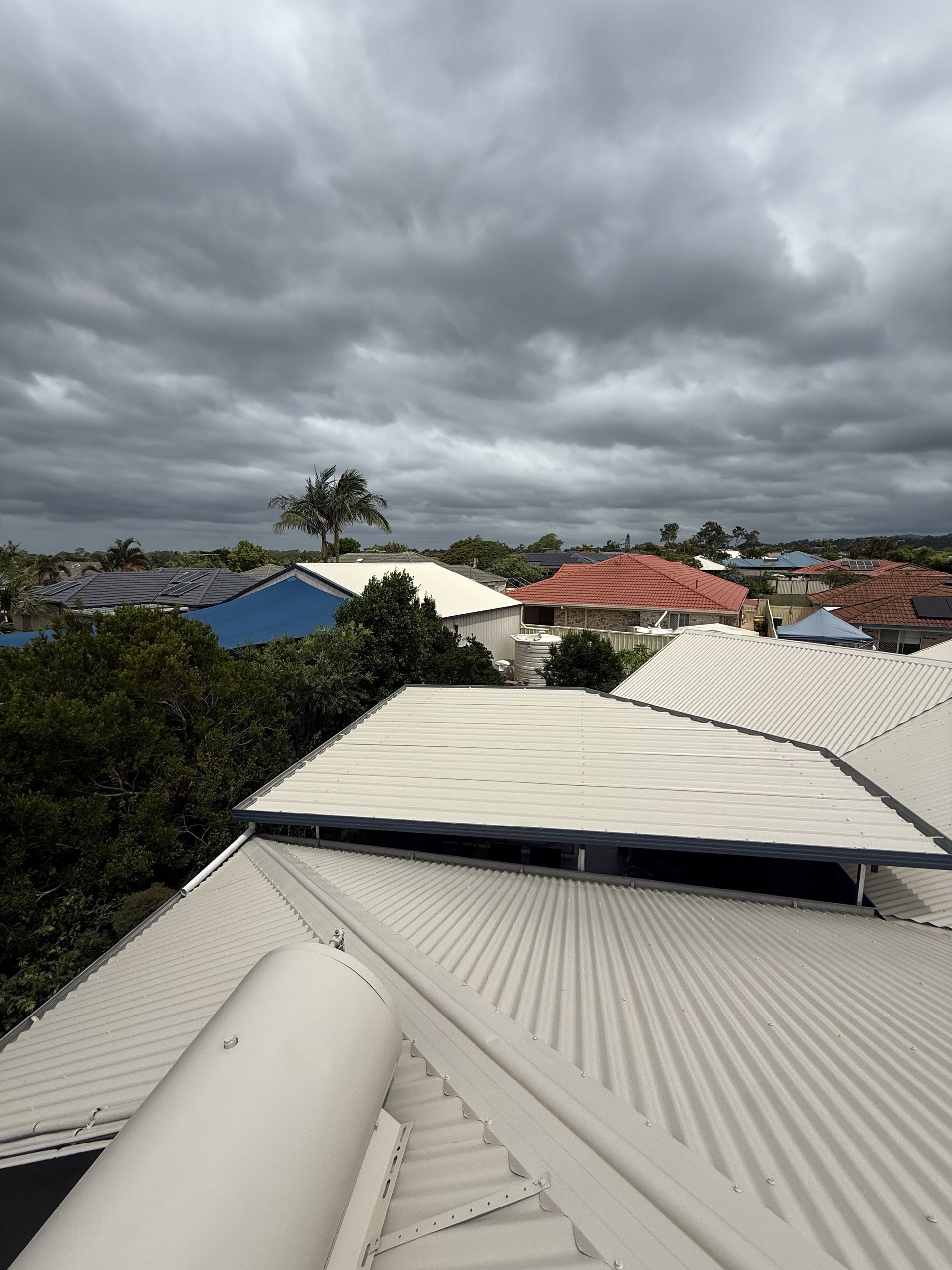 House with a gray metal roof — Metal Roof Restoration in Southport QLD