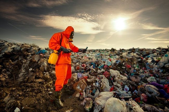 worker clearing a landfill