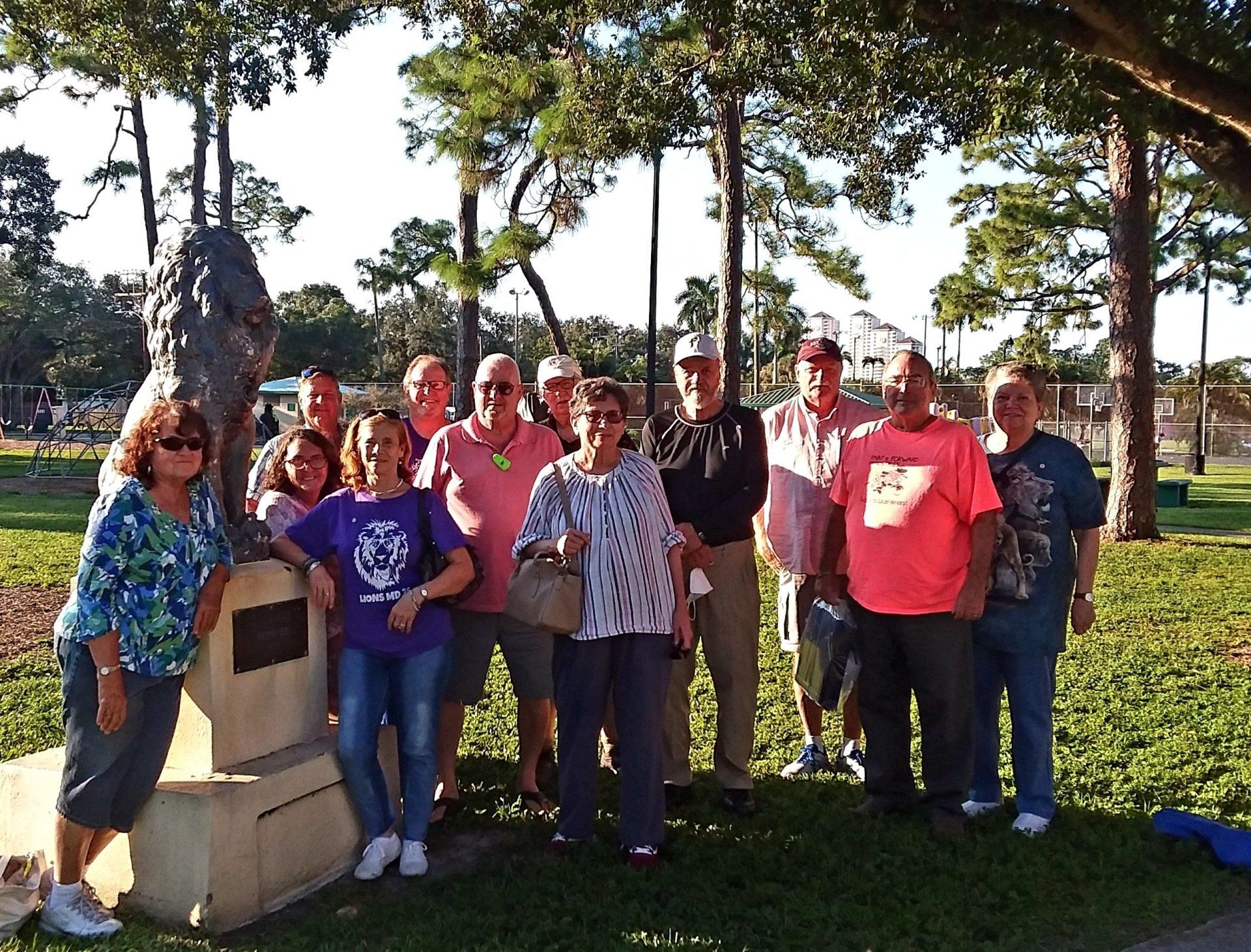 A group of people posing for a picture in a park