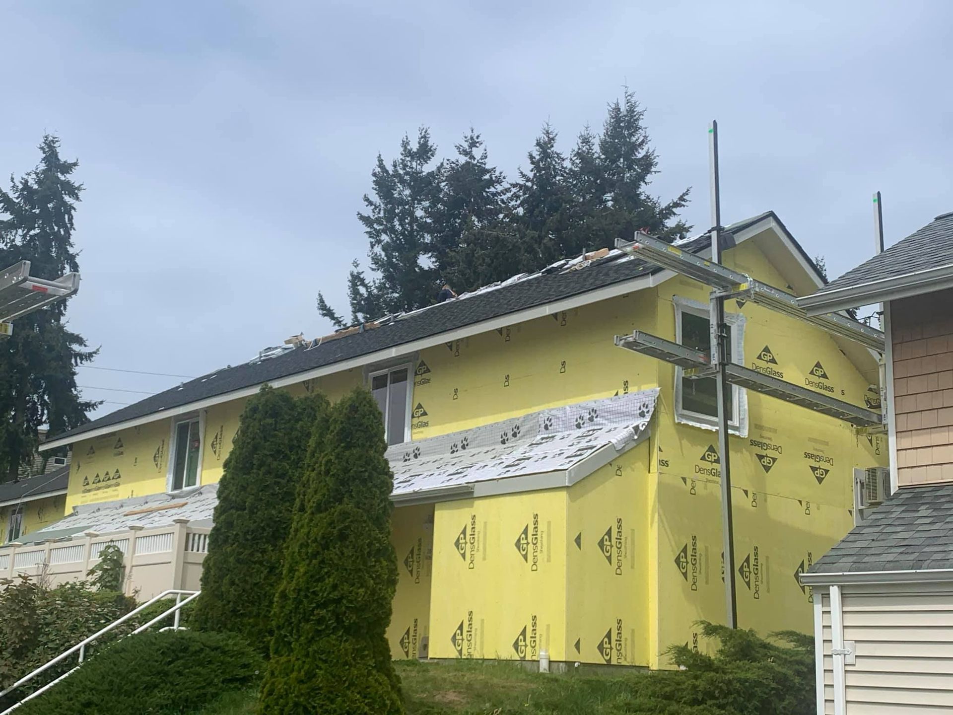 A yellow house is being built with a lot of insulation.