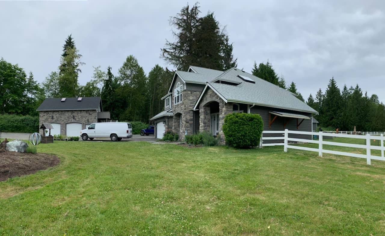 A house with a white van parked in front of it.
