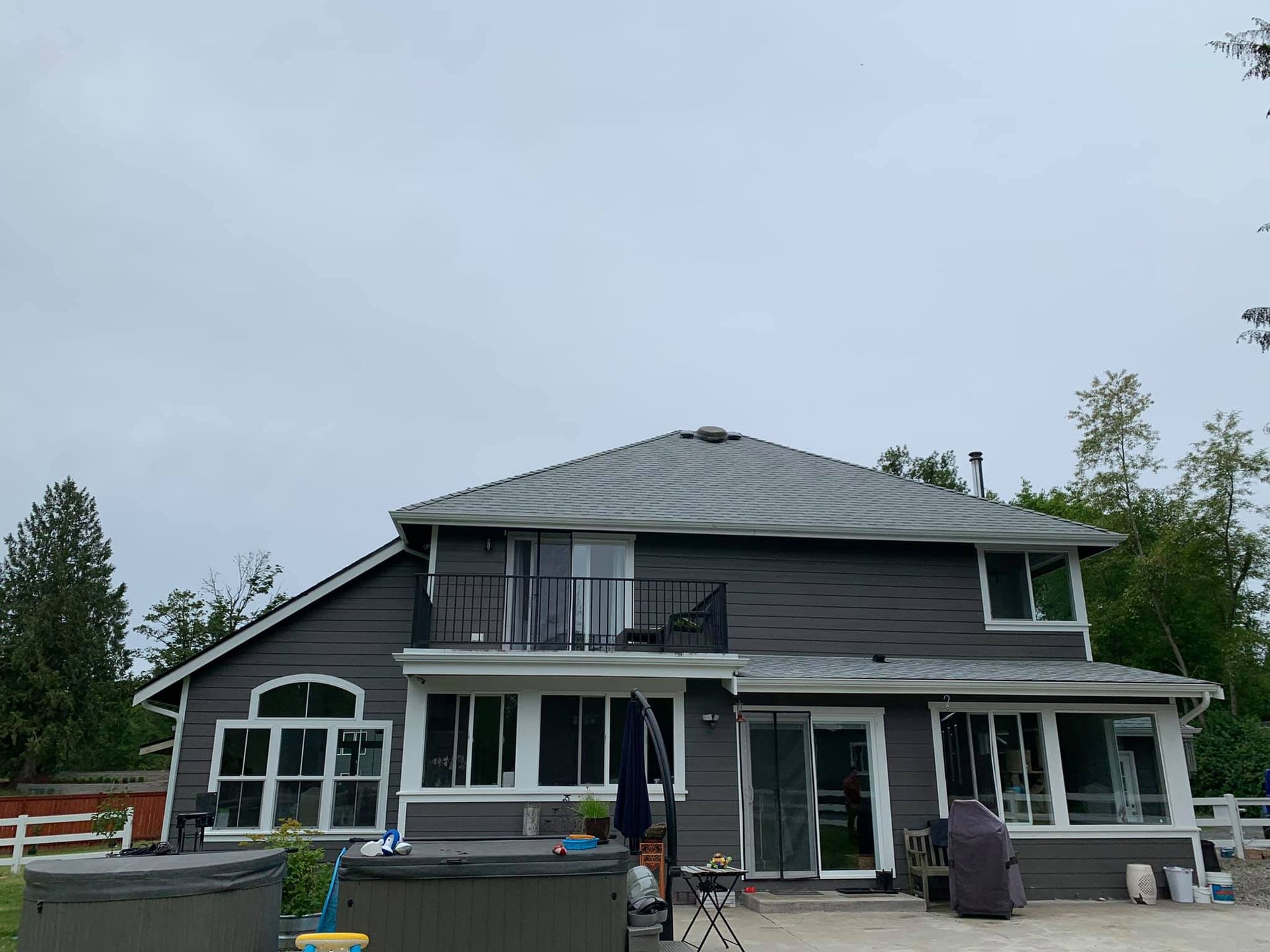 A large house with a hot tub in front of it.