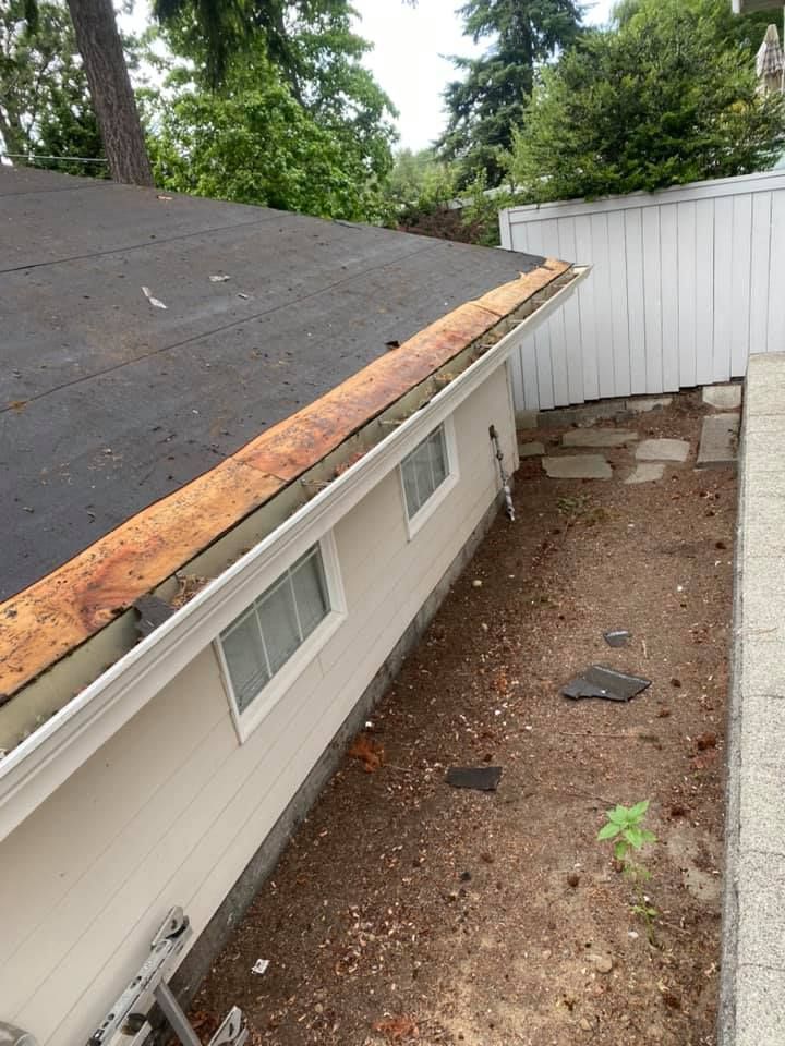 A house with a gutter on the side of it.