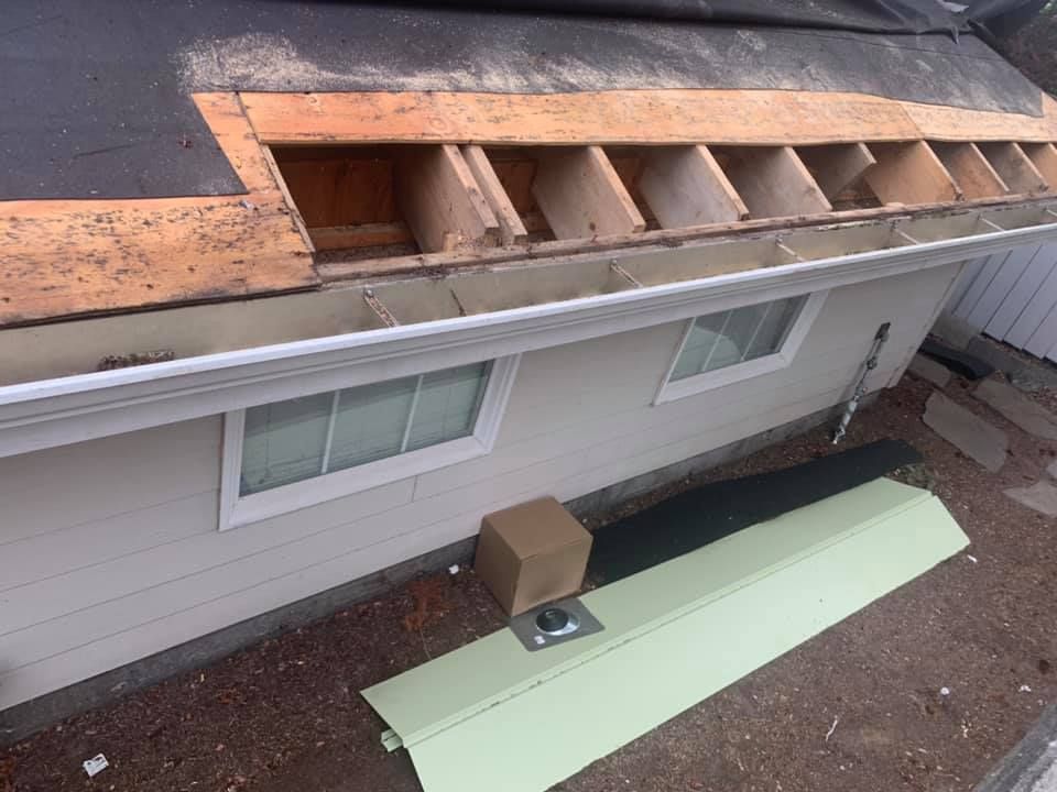 An aerial view of a house with a roof that is being repaired.
