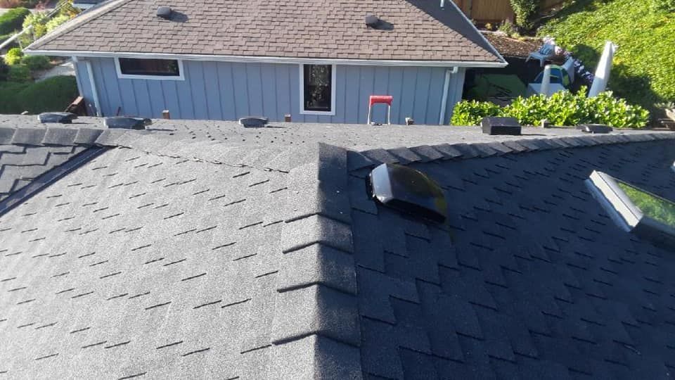 An aerial view of a house with a roof that has shingles on it.