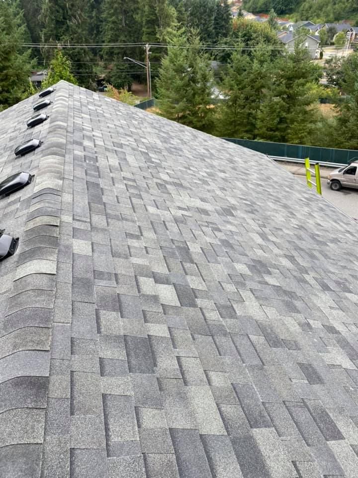 A roof with a lot of shingles and a car parked on it.