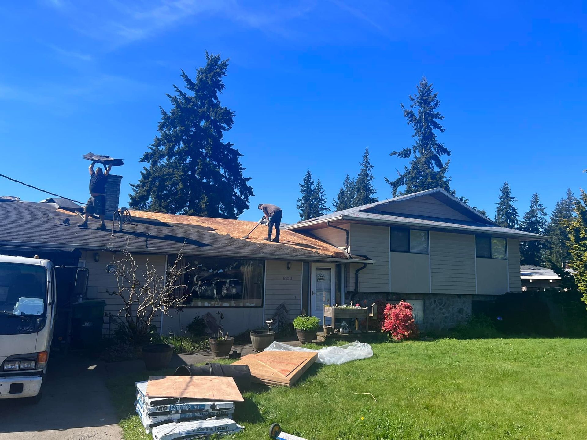 A man is working on the roof of a house.