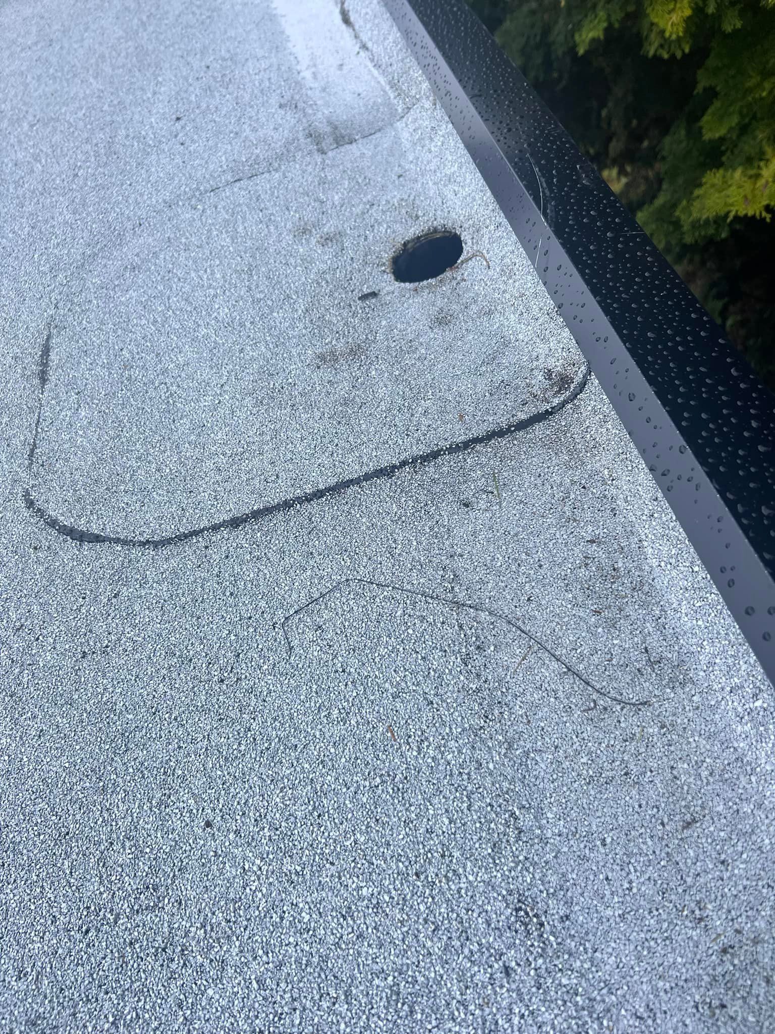 A close up of a gray concrete surface with a hole in it.