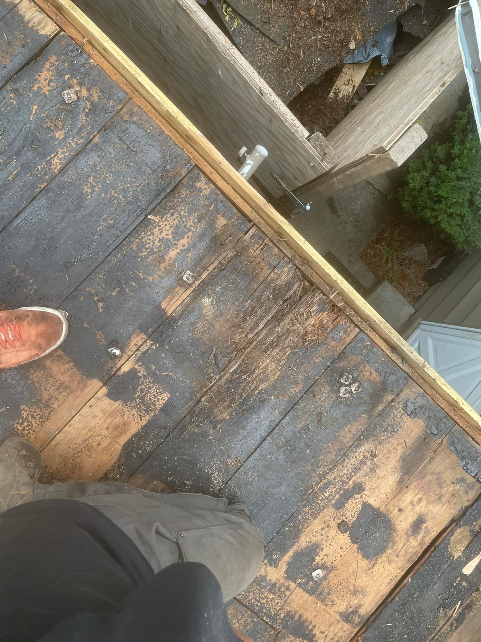 A person is standing on a wooden deck.