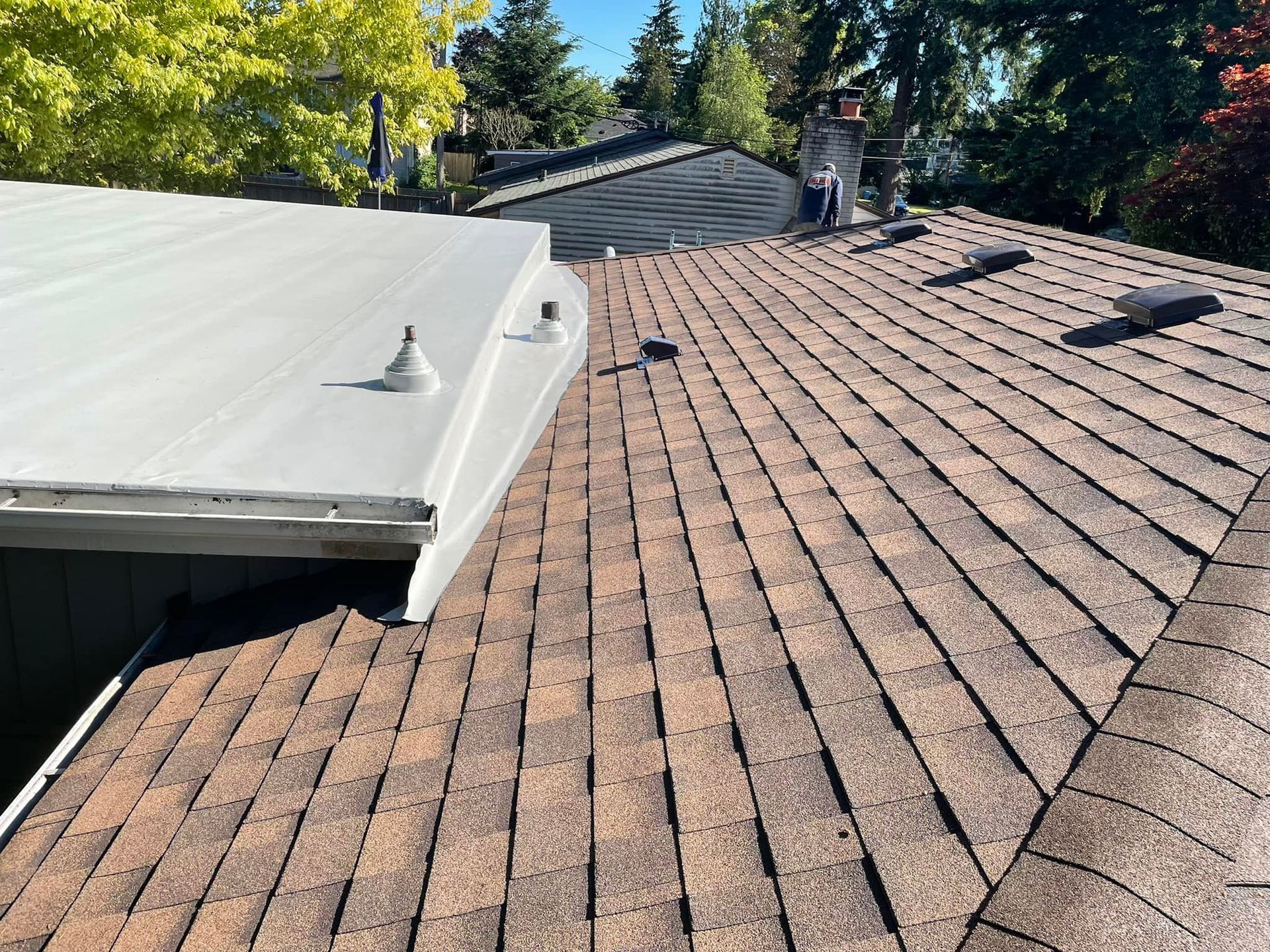 A close up of a roof with a white roof and a brown roof.