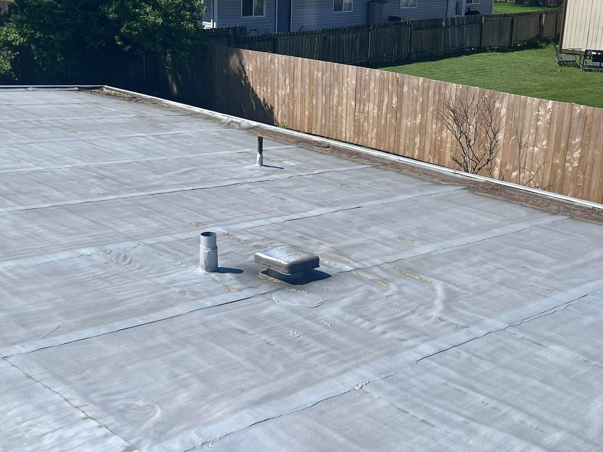 A roof with a wooden fence in the background