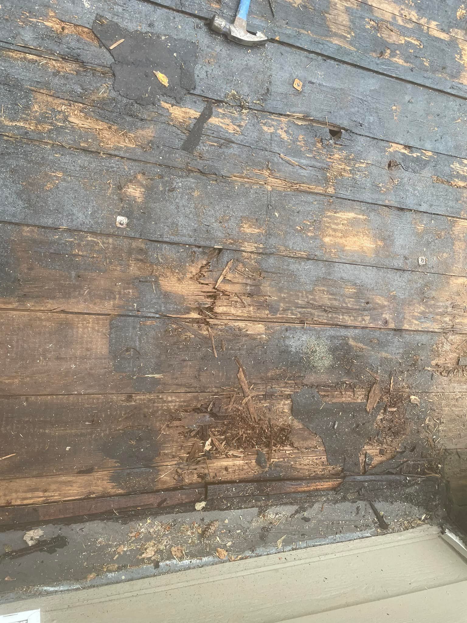 A close up of a wooden floor with a hammer on it.