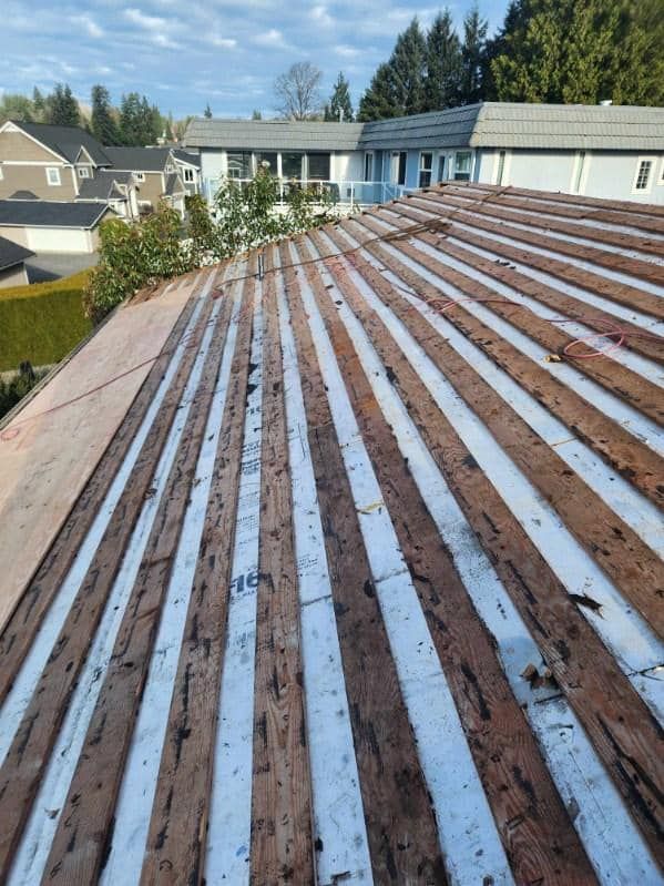 A wooden roof with white stripes on it is sitting on top of a building.