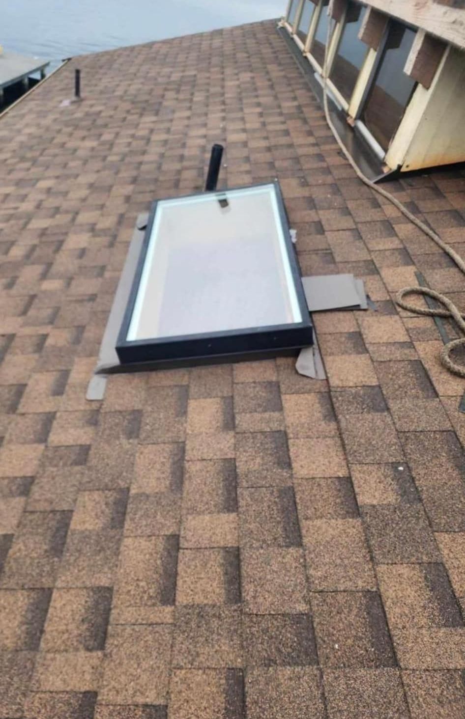 A skylight is sitting on top of a roof.