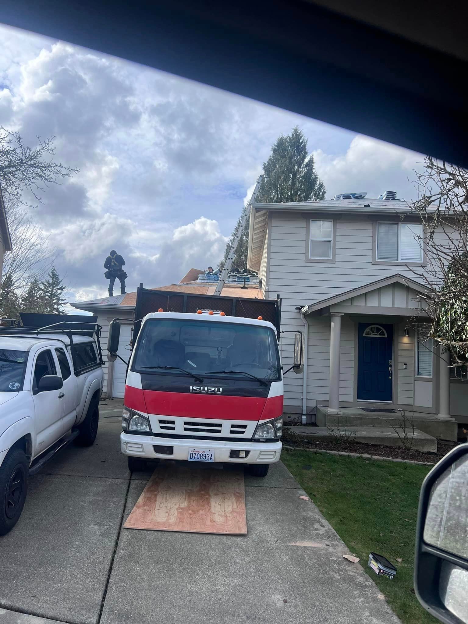 A red and white truck is parked in front of a house.