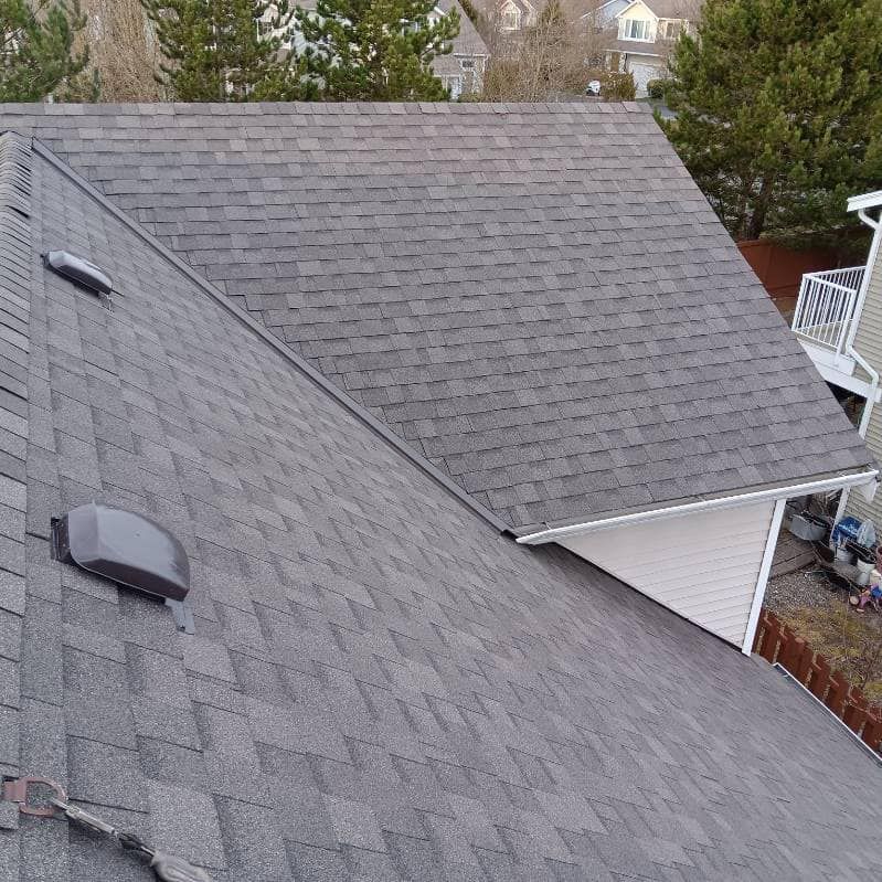 The roof of a house with a roof vent on it.