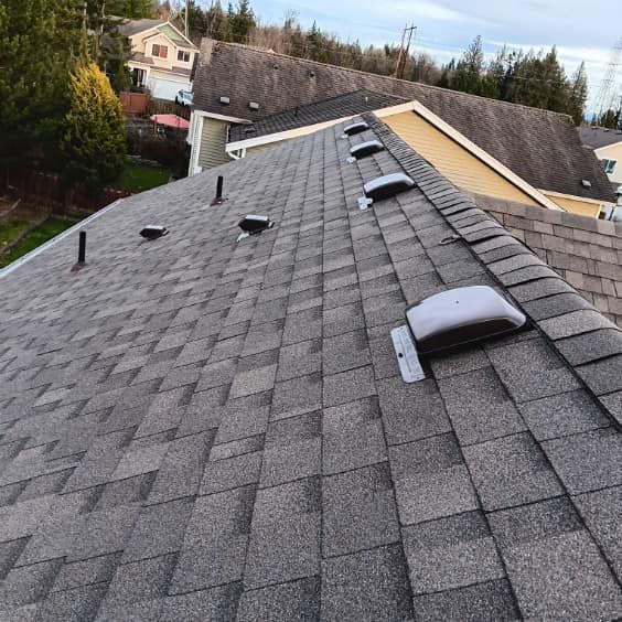 A close up of a roof with a lot of vents on it.