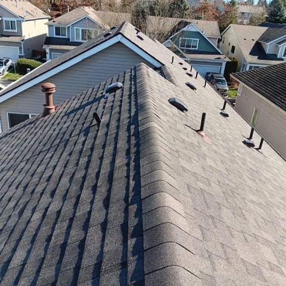 An aerial view of a roof of a house in a residential area.