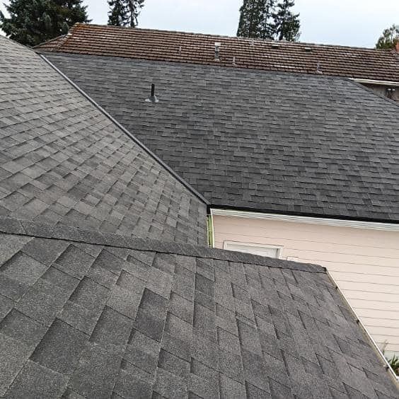 A close up of a roof with shingles on a house.