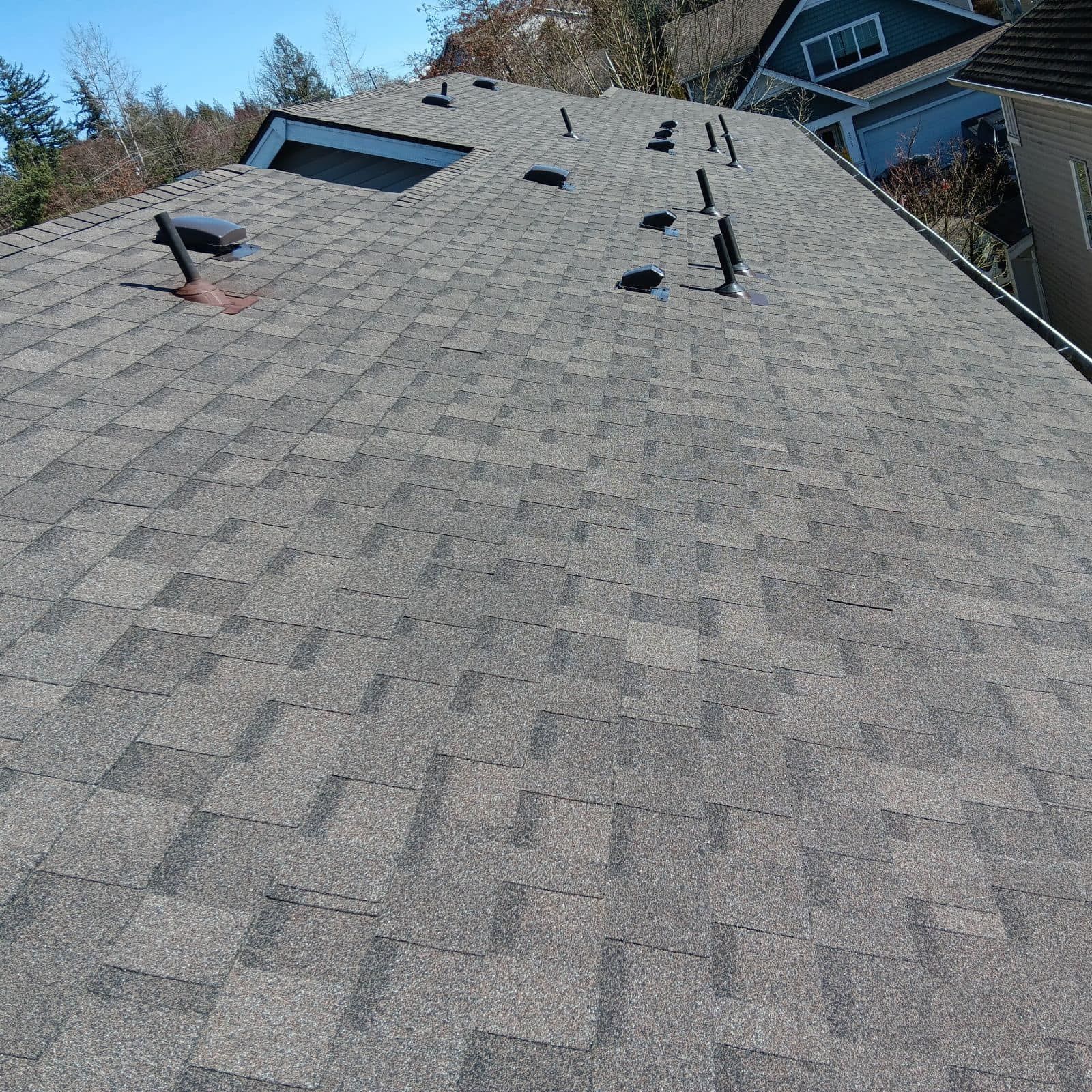 The roof of a house has a lot of shingles on it.