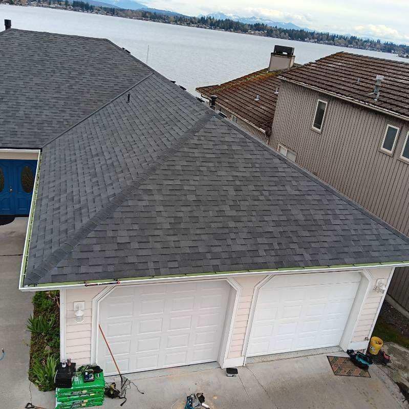 An aerial view of a house with a roof and two garage doors.