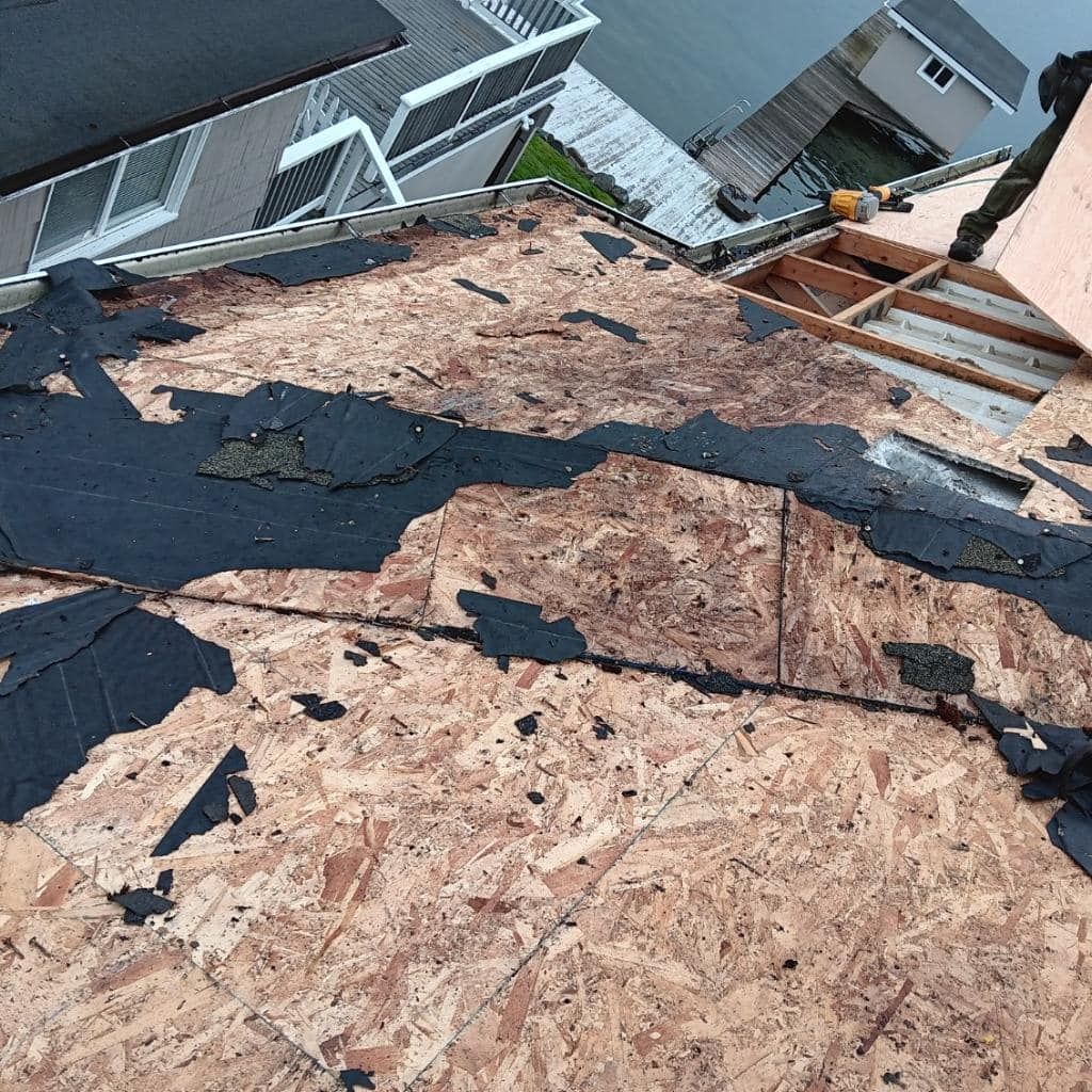 A roof with a lot of pieces of plywood on it is being repaired.
