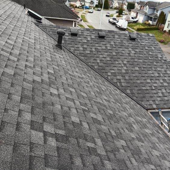 An aerial view of a roof of a house in a residential area.