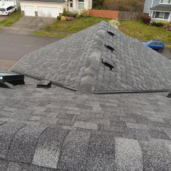 A roof with a lot of shingles on it in a residential area.