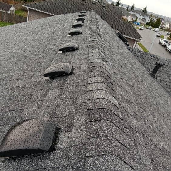 The roof of a house with a lot of vents on it.