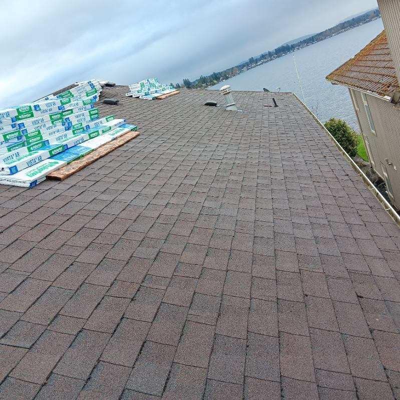 A roof with a view of a body of water is being installed on a house.