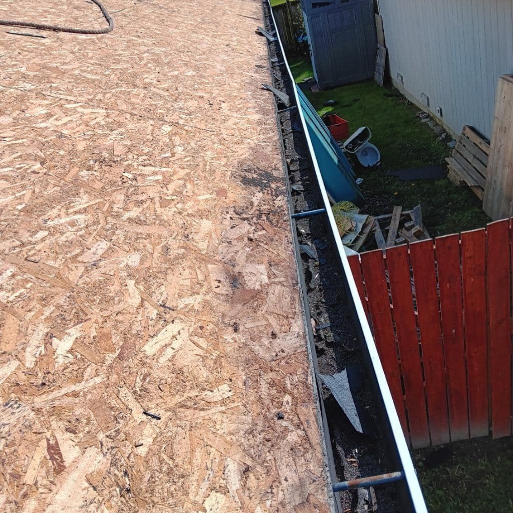 A wooden fence is being built next to a shed