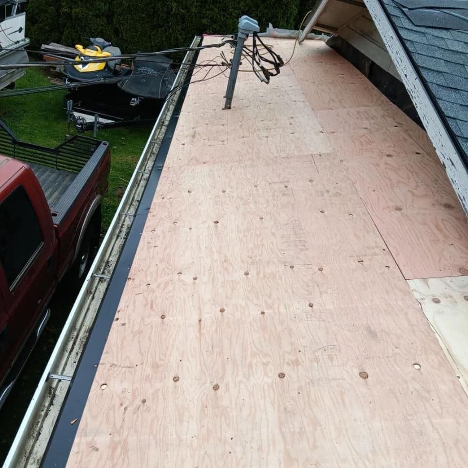 A red truck is parked on the roof of a house