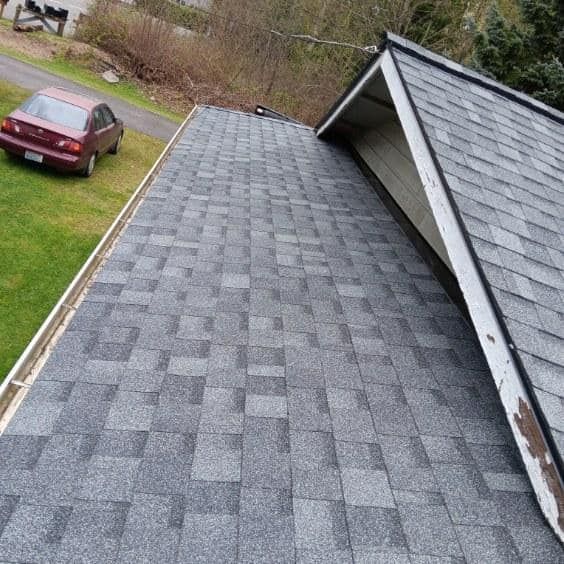 A car is parked on the roof of a house.