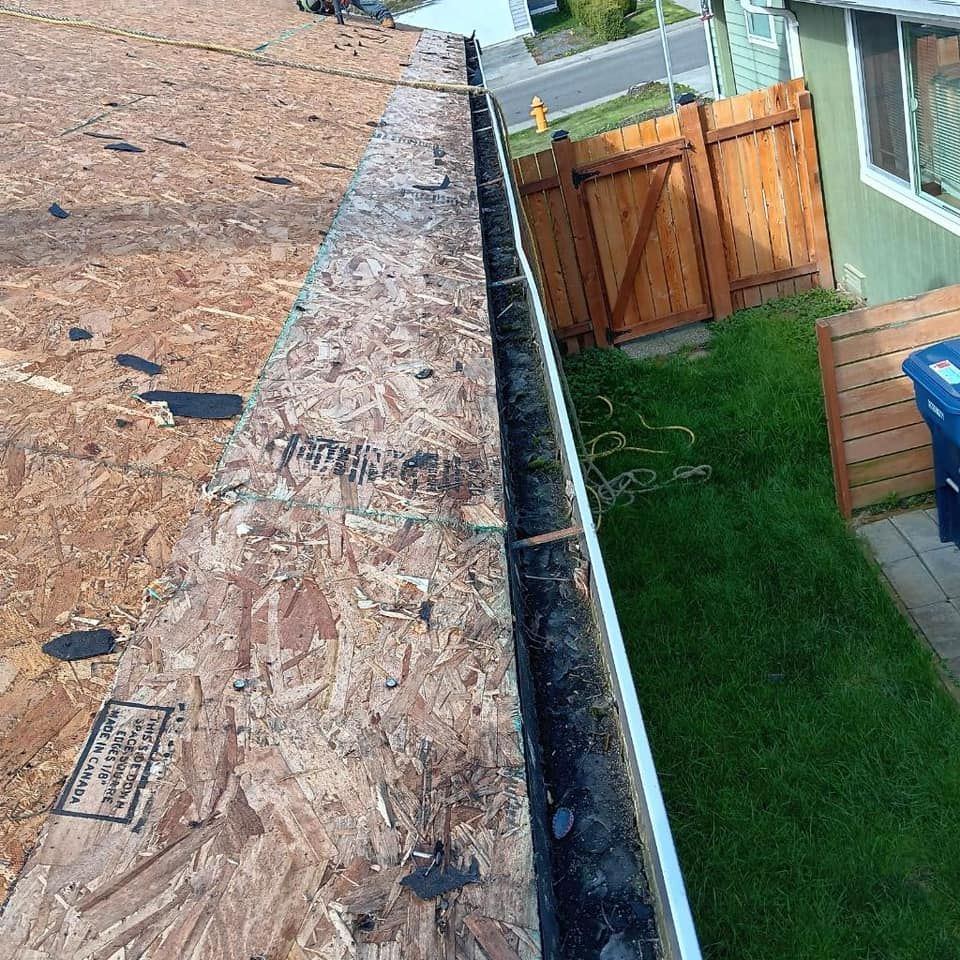 A gutter is being installed on the side of a house.