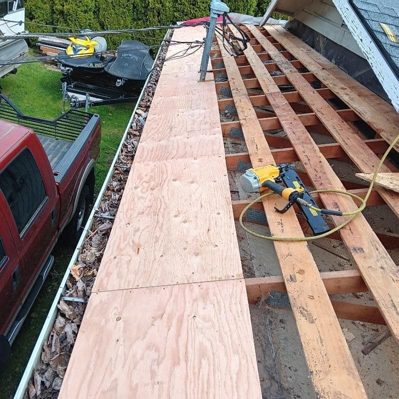 A red truck is parked on the side of a wooden roof.
