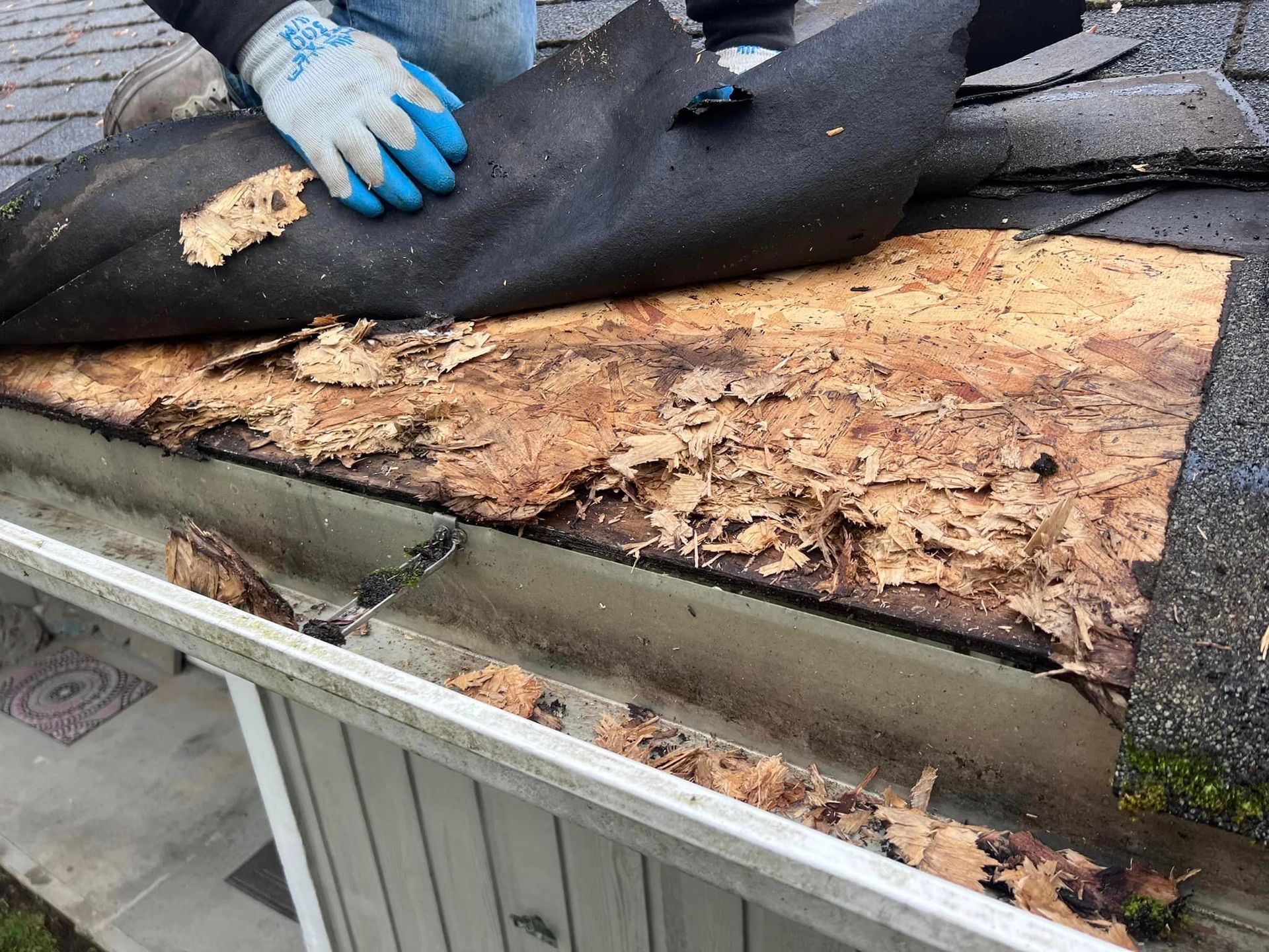 A person is working on the roof of a house.