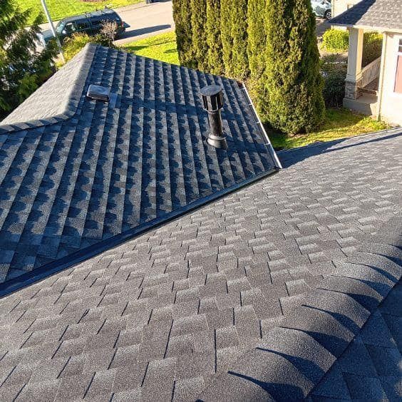 A close up of a roof with a chimney on it.