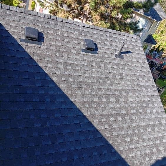 An aerial view of a roof with a shadow on it.