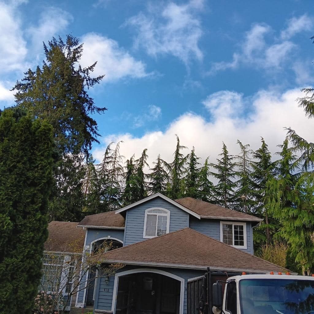 A blue house with a truck parked in front of it